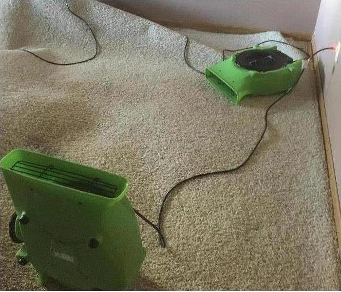 Two air movers on top of carpet floor