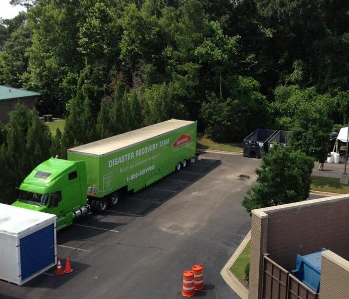 Large green SERVPRO truck on a commercial job site.